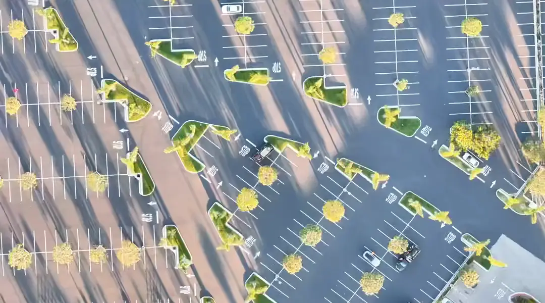 Aerial view of a striped commercial parking lot with landscaped islands